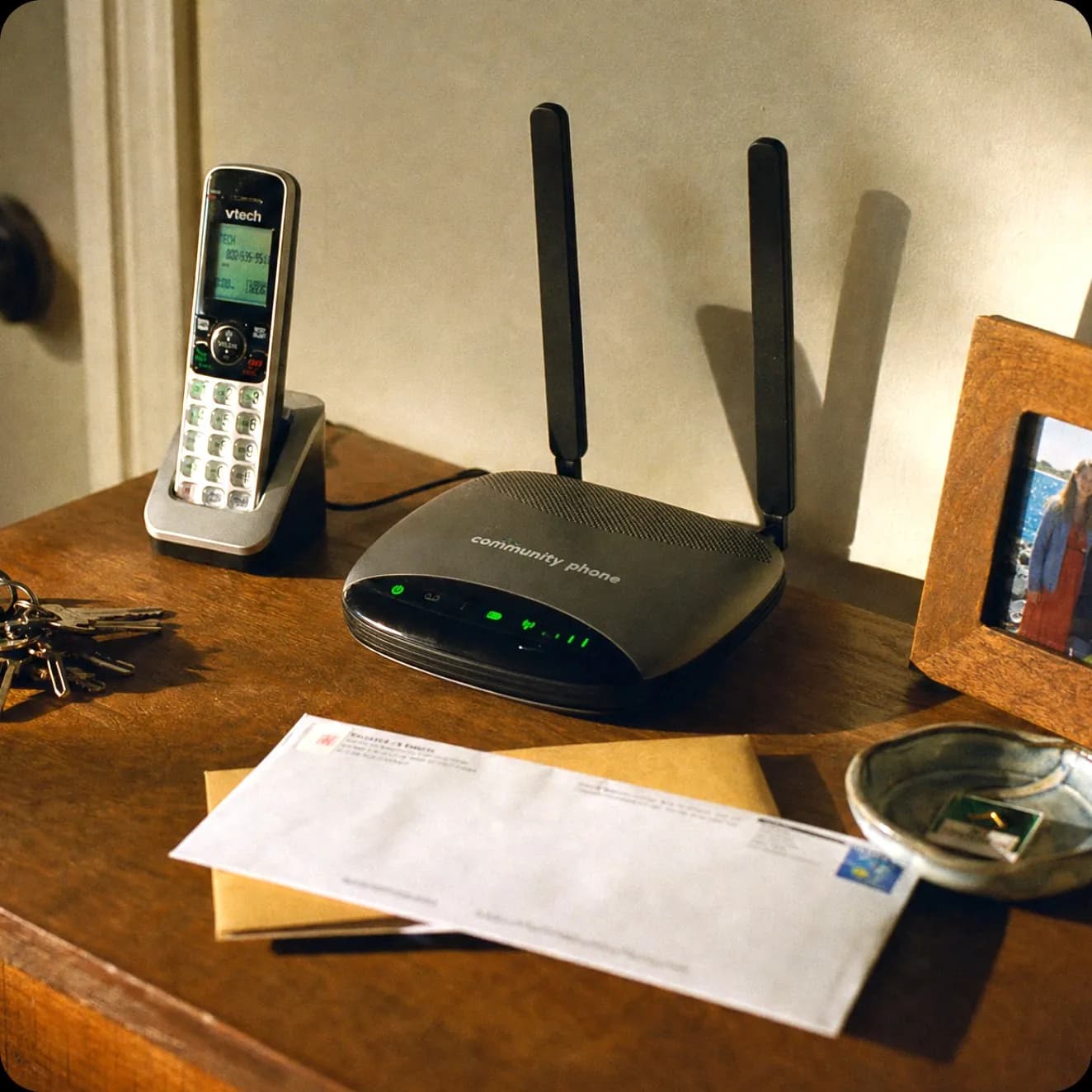 Community Phone Base unit and cordless handset on a side table