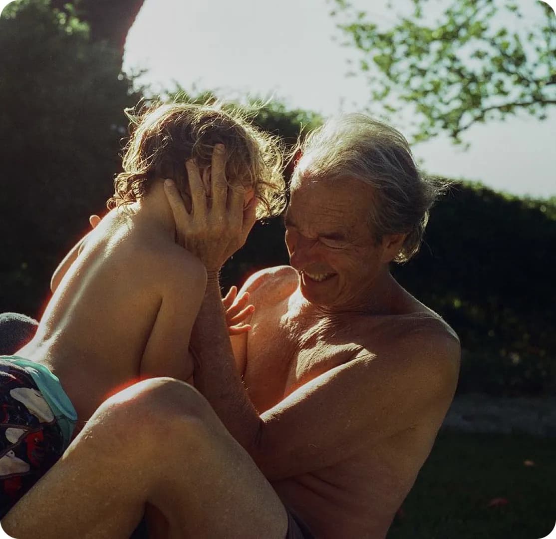 Grandparent and child sharing a joyful outdoor moment